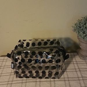 Pink make case in clear and black polka dot.